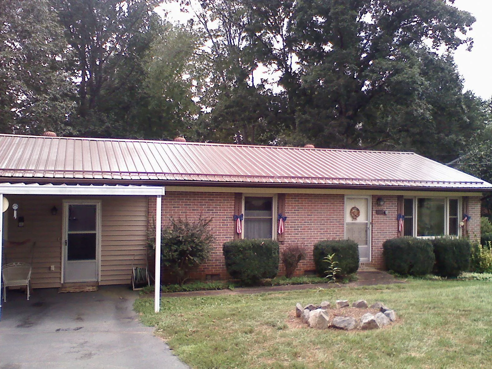Bronze metal roof and carport on a brick ranch home — Roof Repair work by our crew in Murphysboro